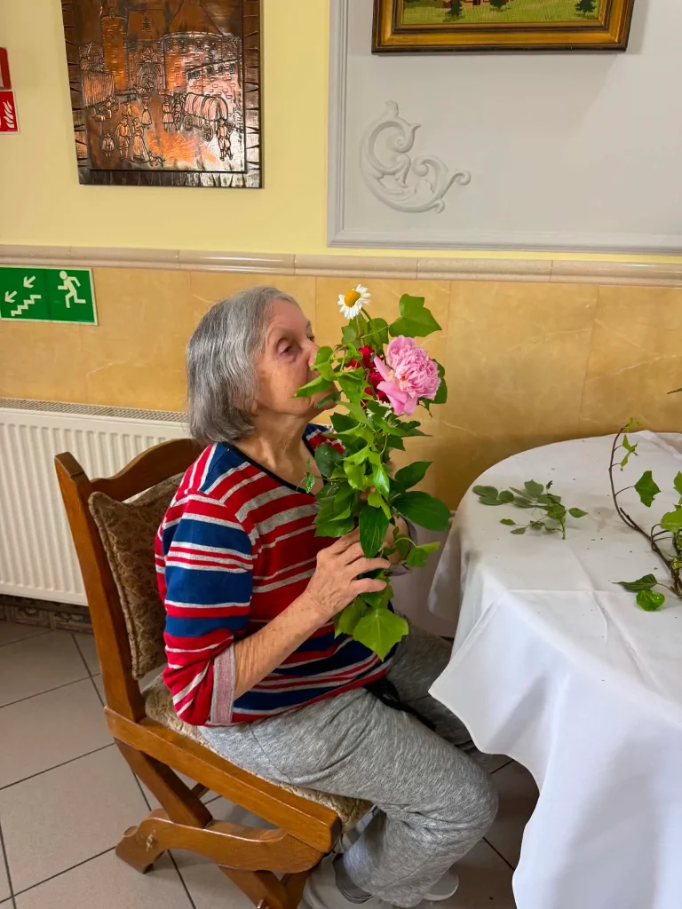 Seniorka trzyma kwiaty